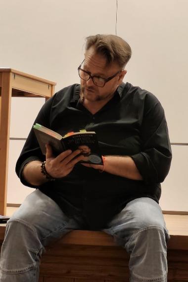Oliver Fischer sitzend bei der Lesung